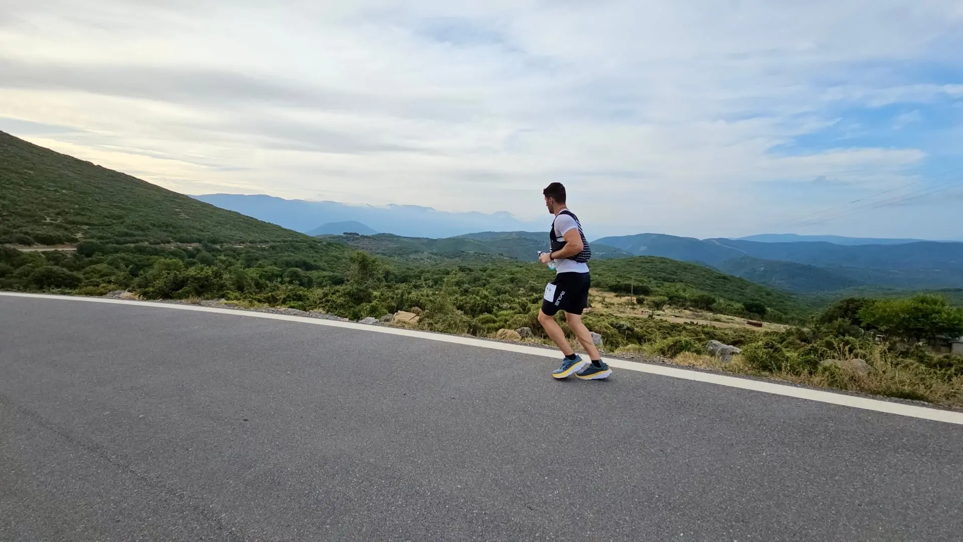 Athlete running through mountainous terrain during endurance training